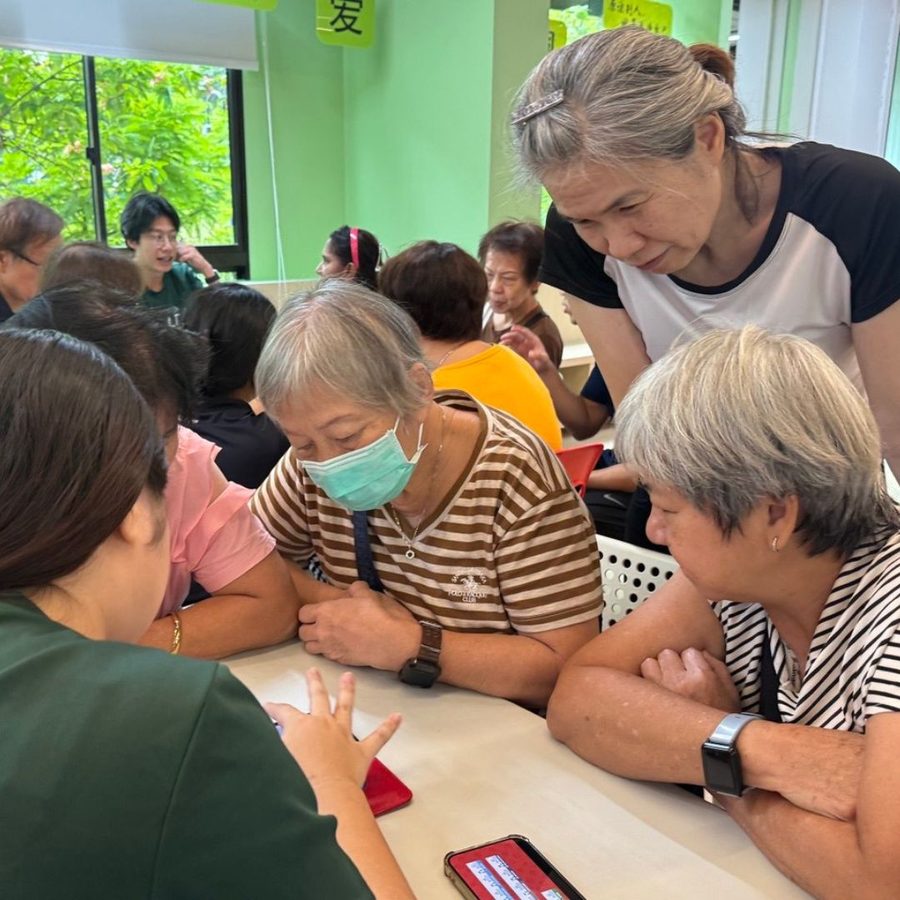 Youth and seniors gathered around a table for storytelling